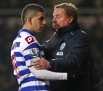 Queens Park Rangers manager Harry Redknapp talks to Adel Taarabt as he is substituted during their English Premier League soccer match against West Ham United at Upton Park in London